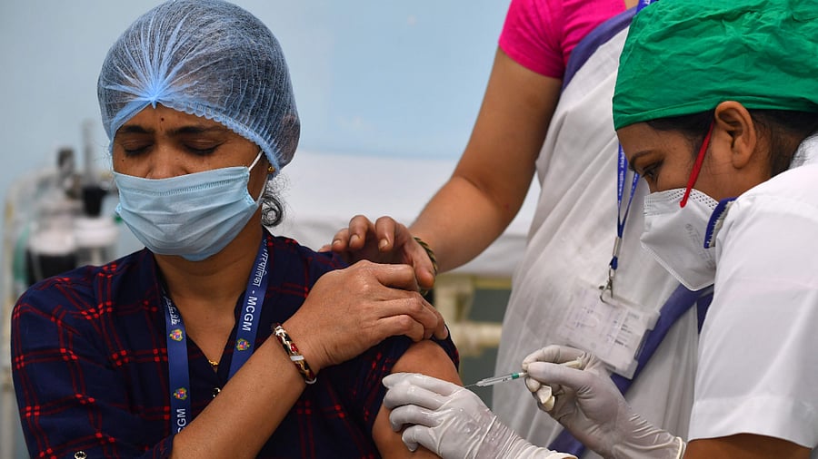 A medical worker inoculates a colleague with a Covid-19 coronavirus vaccine at the Rajawadi Hospital in Mumbai. Credit: AFP Photo