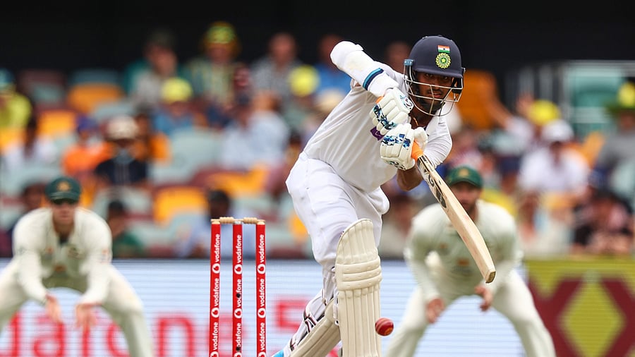 Washington Sundar drives a ball on day three of the fourth cricket Test match between Australia and India at the Gabba in Brisbane. Credit: AFP Photo
