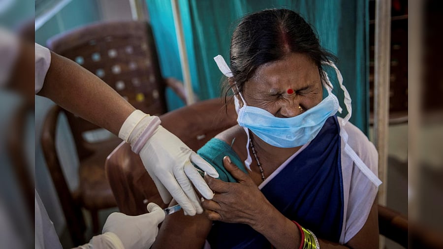 A healthcare worker reacts as she receives a dose of COVISHIELD, a COVID-19 vaccine manufactured by Serum Institute of India, during one of the world's largest COVID-19 vaccination campaigns at Mathalput Community Health Centre in Koraput district of the eastern state of Odisha, India, January 16, 2021. Credit: Reuters Photo