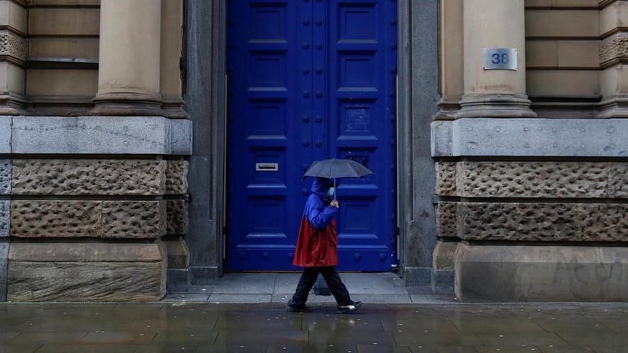 A woman walks past a former bank building, amidst the spread of the coronavirus disease (COVID-19), in Manchester, Britain, January 18, 2021. Credit: Reuters Photo