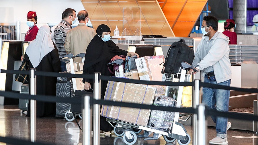 Travellers, mask-clad due to the Covid-19 coronavirus pandemic. Credit: AFP Photo