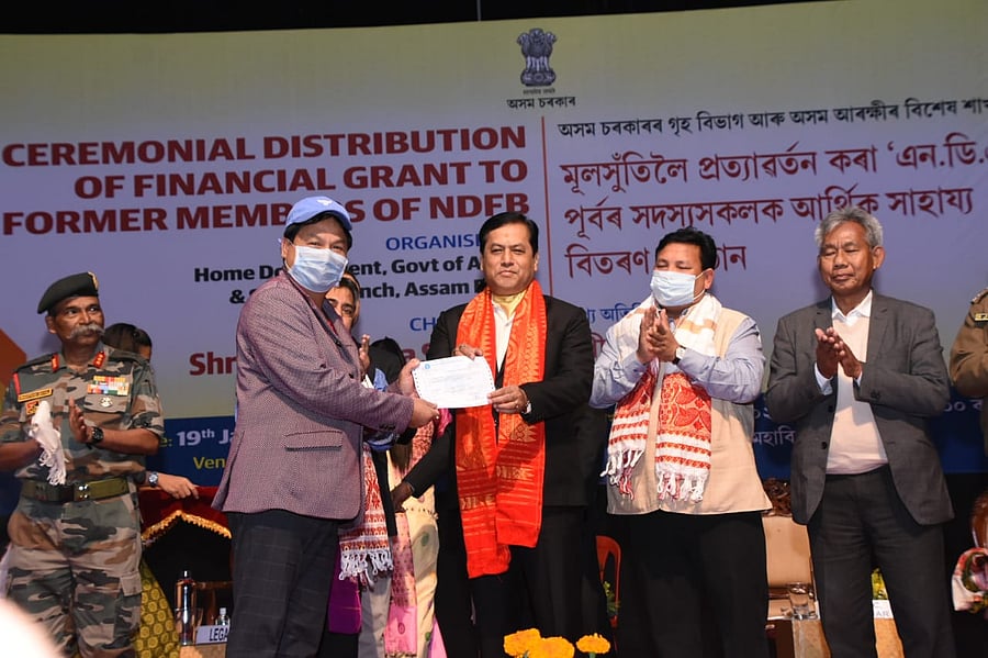 Assam CM Sarbananda Sonowal handing over financial grant certificates to former members of NDFB, a disbanded militant group, in Guwahati on Tuesday. Credit: Assam government