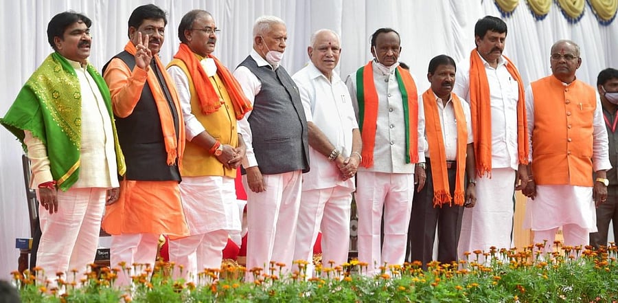 Karnataka Governor Vajubhai Vala along with Karnataka Chief Minister BS Yediyurappa and newly inducted ministers during the oath-taking ceremony, at Raj Bhavan in Bengaluru, Wednesday, Jan. 13, 2021. Credit: PTI Photo