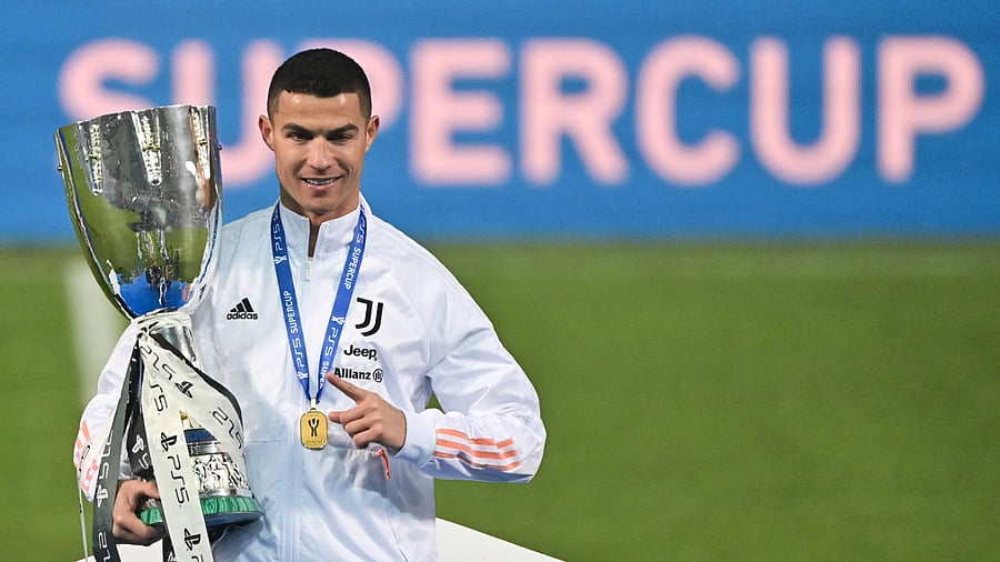Juventus' Portuguese forward Cristiano Ronaldo poses with the winners' trophy after the Italian Super Cup (Supercoppa italiana) football match between Juventus and Napoli at the Mapei stadium - Citta del Tricolore in Reggio Emilia. Credit: AFP Photo