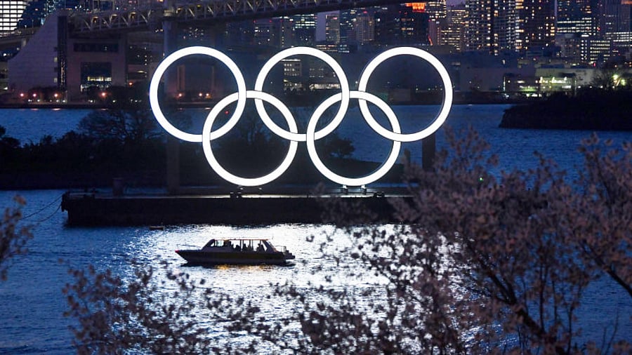 A boat sails past the Tokyo 2020 Olympic Rings on March 25, 2020 in Tokyo, Japan. Credit: Getty Images