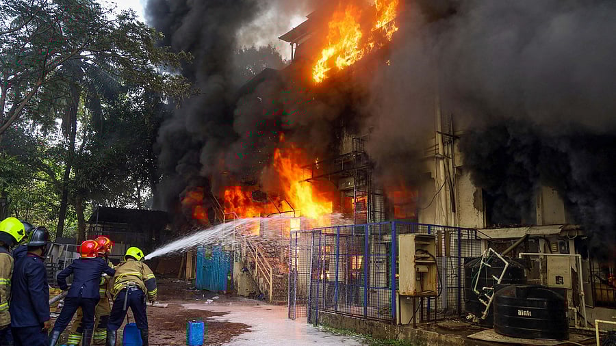 Fire brigade personnel douse a fire which broke out at Biosense facility, in Thane. Credit: PTI