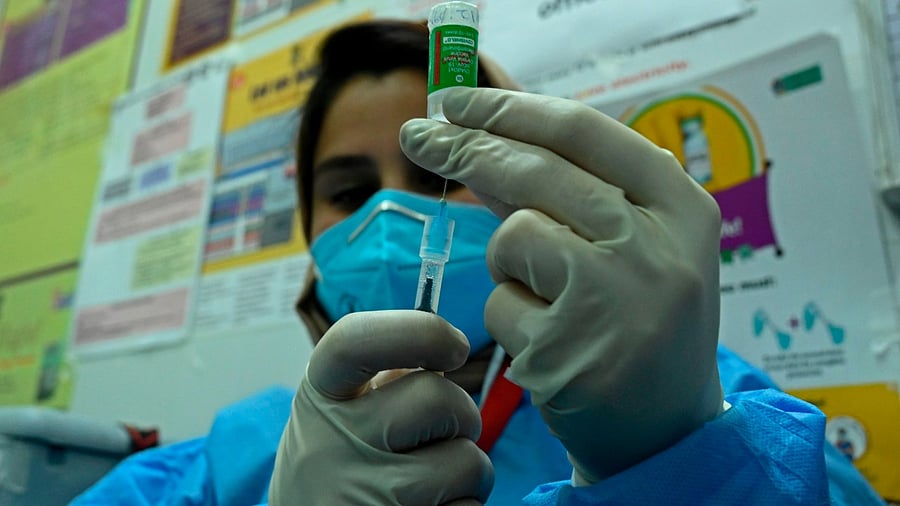 A medical worker prepares to inoculate a staff member with Covid-19 coronavirus vaccine at the G.B. Pant hospital in Srinagar on January 22, 2021. Credit: AFP Photo