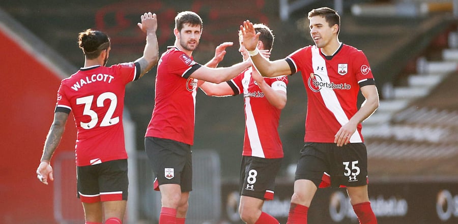 Southampton's Jan Bednarek, Jack Stephens and Theo Walcott celebrate after the match. Credit: Reuters Photo