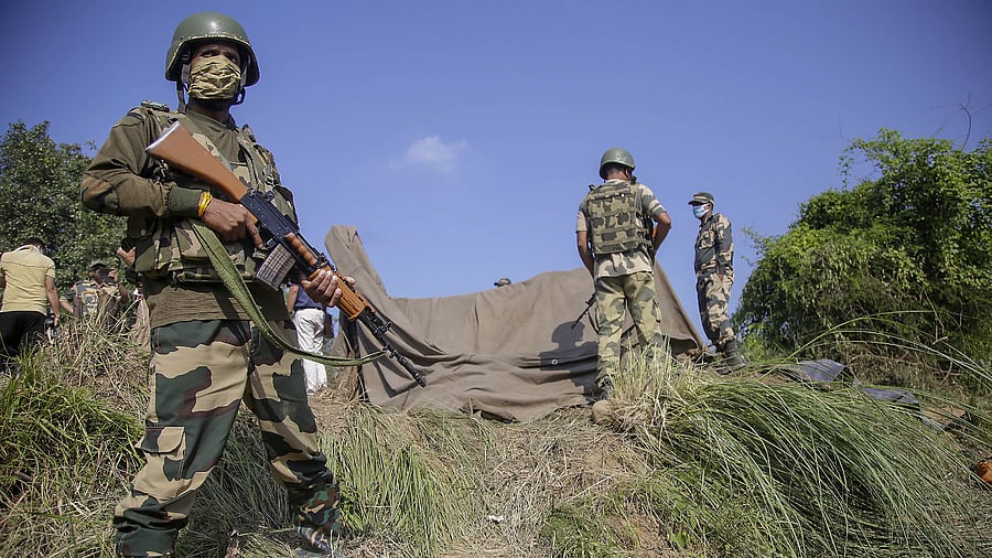 Border Security Force (BSF) personnel stand near a tunnel, originating from Pakistan, beneath the Indo-Pak international border fence, in J&K's Samba district, Saturday, Aug. 29, 2020. Credit: PTI File Photo