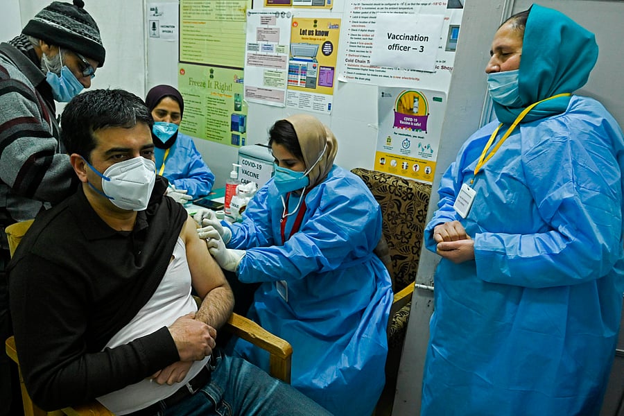 A medical worker inoculates a staff member with Covid-19 coronavirus vaccine at the G.B. Pant hospital in Srinagar on January 22, 2021. Credit: AFP Photo