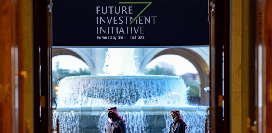 Mask-clad guard stand at the entrance of the fourth edition of the Future Investment Initiative (FII) conference at the capital Riyadh's Ritz-Carlton hotel. Credit: AFP Photo