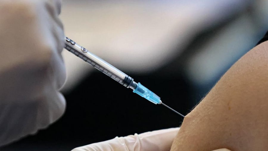 An Israeli health worker injects a dose of the Pfizer-BioNtech Covid-19 vaccine, at the Clalit Health Services installed at the Pais Arena Sport Hall in Jerusalem, on January 21, 2021. Credit: AFP Photo