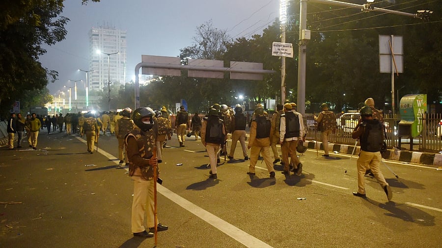 Police personnel keep a vigil after clashes with farmers and their supporters during tractor march on Republic Day, at ITO in New Delhi. Credit: PTI File Photo