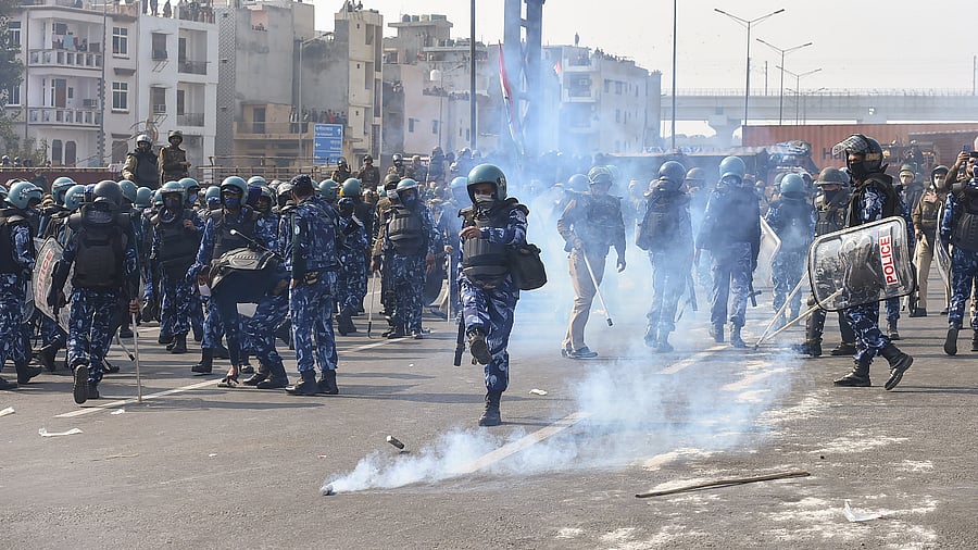 Police personnel use teargas shells to disperse farmers during their tractor parade on Republic Day, in New Delhi. Credit: PTI Photo