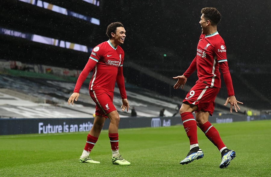 Liverpool's Trent Alexander-Arnold celebrates scoring their second goal with Roberto Firmino. Credit: Reuters Photo