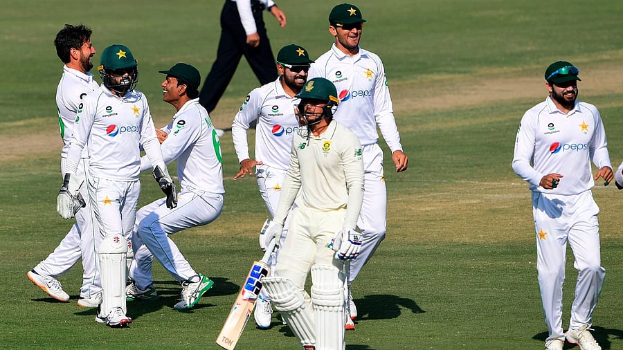 Pakistan's players celebrate after the dismissal of South Africa's captain Quinton de Kock (C) during the fourth day of the first cricket Test match between Pakistan and South Africa at the National Stadium in Karachi on January 29, 2021. Credit: AFP Photo