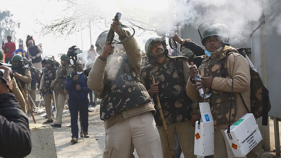 A security personnel fires a tear gas shell during clashes between farmers and locals as the farmers continue to protest. Credit: AFP Photo