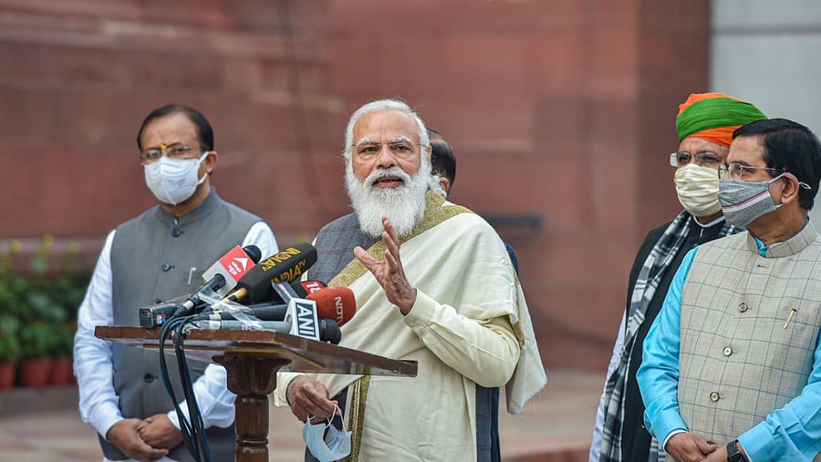 Prime Minister Narendra Modi addresses media personnel as he arrives at Parliament House to attend the Budget session, in New Delhi. Credit: PTI.