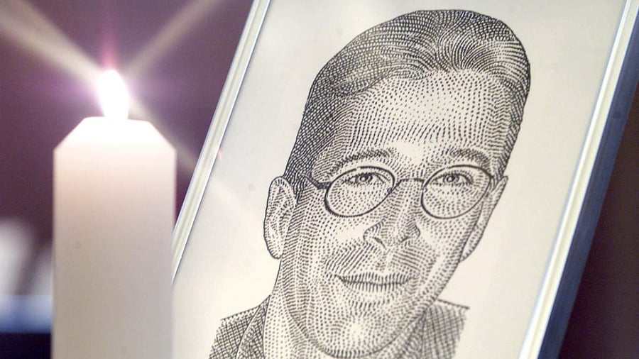 A portrait of the Wall Street Journal's reporter Daniel Pearl stands with a candle at the altar at Fleet Street's journalists chapel St Brides Church prior to a memorial service in London March 5, 2002. Credit: Reuters file photo.