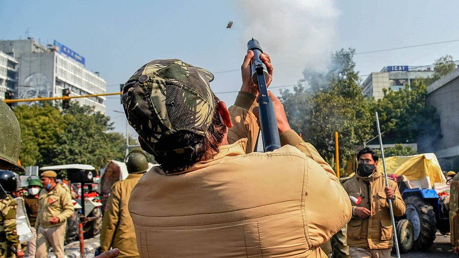 Police fire teargas shells to disperse protesting farmers who were attempting to break barricades at ITO during their 'tractor march' on Republic Day, in New Delhi. Credit: PTI Photo