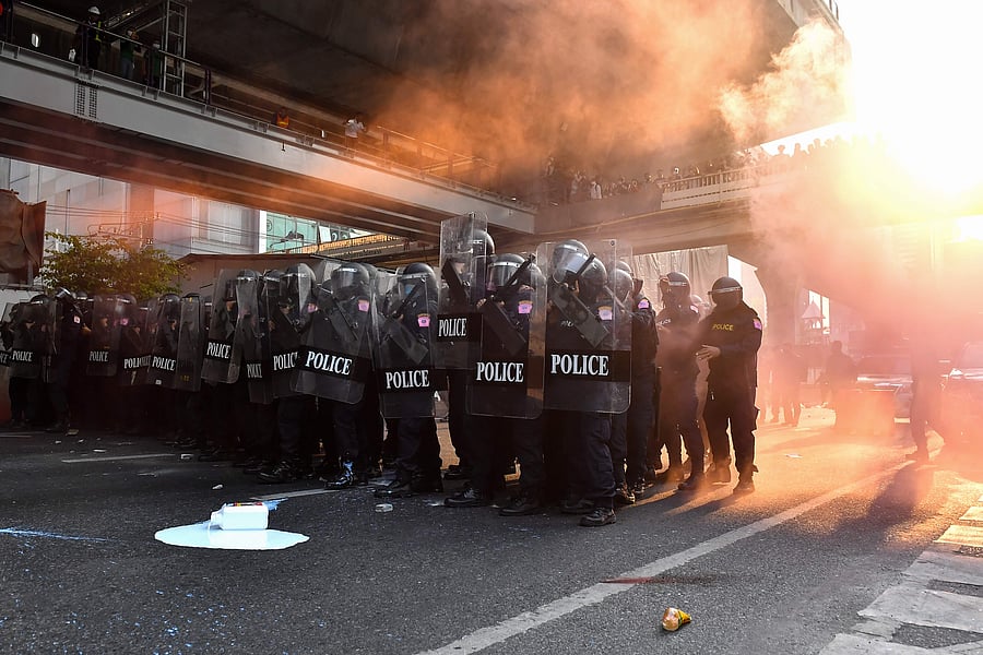 Riot police prepare to advance on Thai pro-democracy protesters in Bangkok on February 1, 2021, close to where Myanmar migrants were demonstrating after Myanmar's military detained the country's de facto leader Aung San Suu Kyi and the country's president in a coup. Credit: AFP Photo