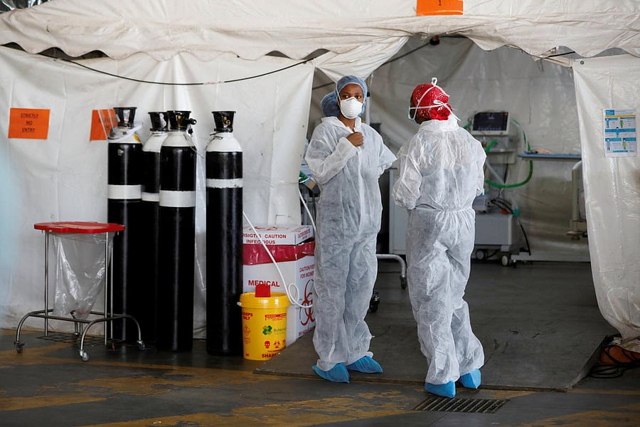 Healthcare workers chat at a temporary ward set up during the coronavirus disease (COVID-19) outbreak, at Steve Biko Academic Hospital in Pretoria, South Africa. Credit: Reuters photo.