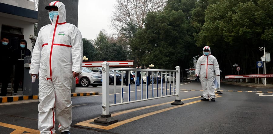 Security personnel look on during the visit by members of the WHO team tasked with investigating the origins of the coronavirus disease.. Credit: Reuters Photo