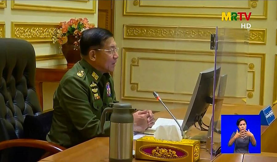 This screengrab provided via AFPTV and taken from a broadcast by Myanmar Radio and Television (MRTV) in Myanmar on February 2, 2021 shows military chief General Min Aung Hlaing chairing the first cabinet meeting at the Presidential Palace in Naypyidaw. Credit: AFP. 