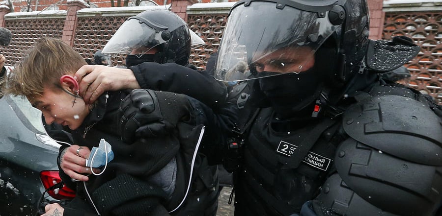 Police officers detain a young demonstrator during a protest near the Matrosskaya Tishina prison where Alexei Navalny is being held, in Moscow, Russia. Credit: PTI Photo