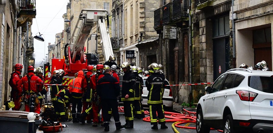 Firefighters work at the site where a large explosion in a garage destroyed the building as well as two neighbouring ones on February 6, 2021 in Bordeaux' Chartrons district. Credit: AFP Photo