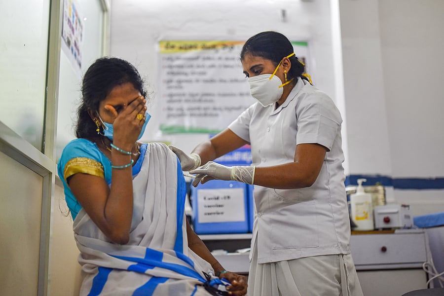 A medic administers the first dose of Covishield vaccine to a frontline worker. Credit: PTI Photo