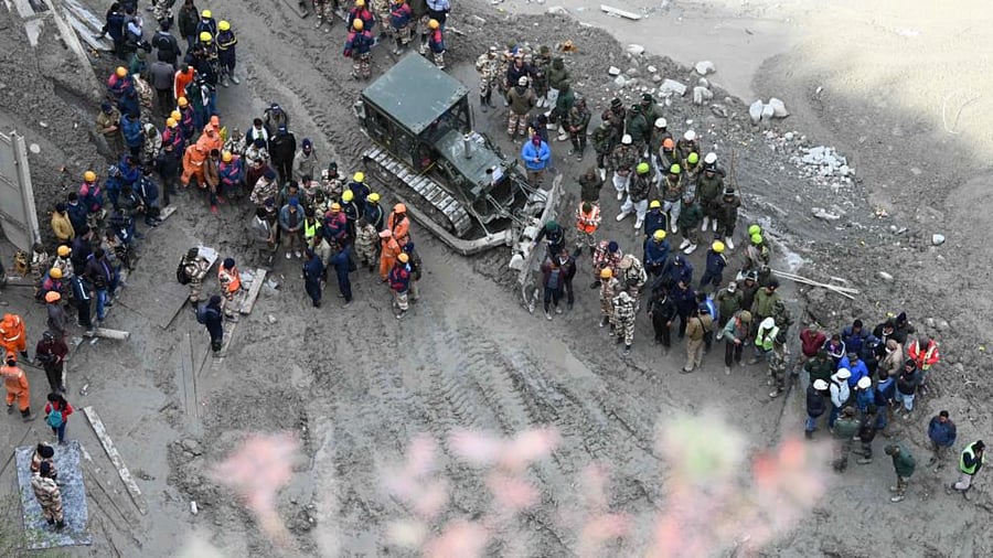 Rescue teams gather near the entrance of a tunnel blocked with mud and debris, where workers are trapped, in Tapovan of Chamoli district on February 9, 2021 following a flash flood thought to have been caused when a glacier burst on February 7.  Credit: AFP Photo