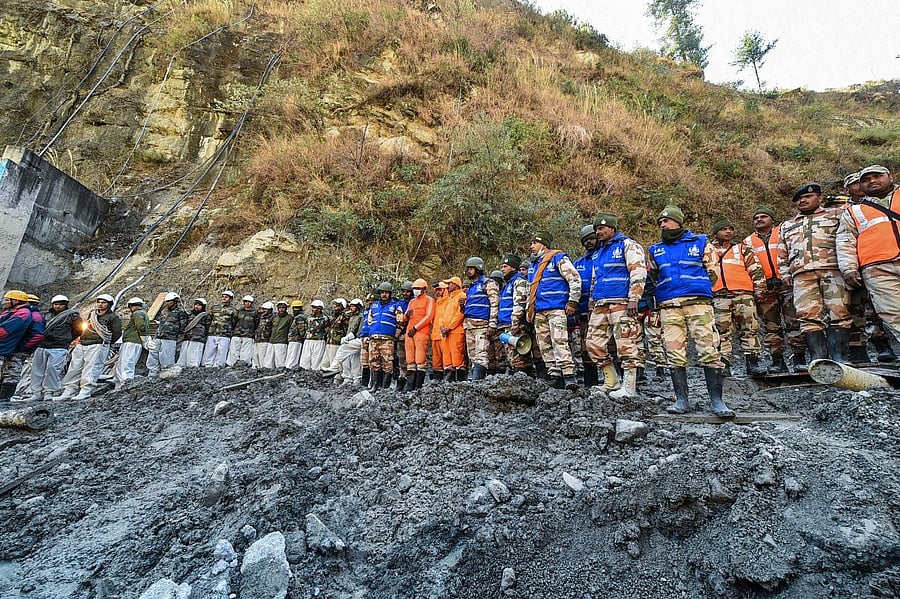 Rescue teams stand near the Tapovan Tunnel, following the Sunday's glacier burst in Joshimath causing a massive flood in the Dhauli Ganga river, in Chamoli district of Uttarakhand, Thursday, Feb. 11, 2021. Credit: PTI Photo