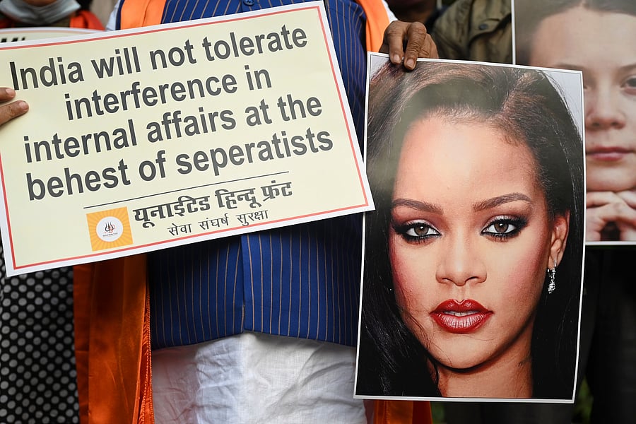 Activists of United Hindu Front (UHF) hold a placard and pictures of Swedish climate activist Greta Thunberg and Barbadian singer Rihanna. Credit: AFP Photo