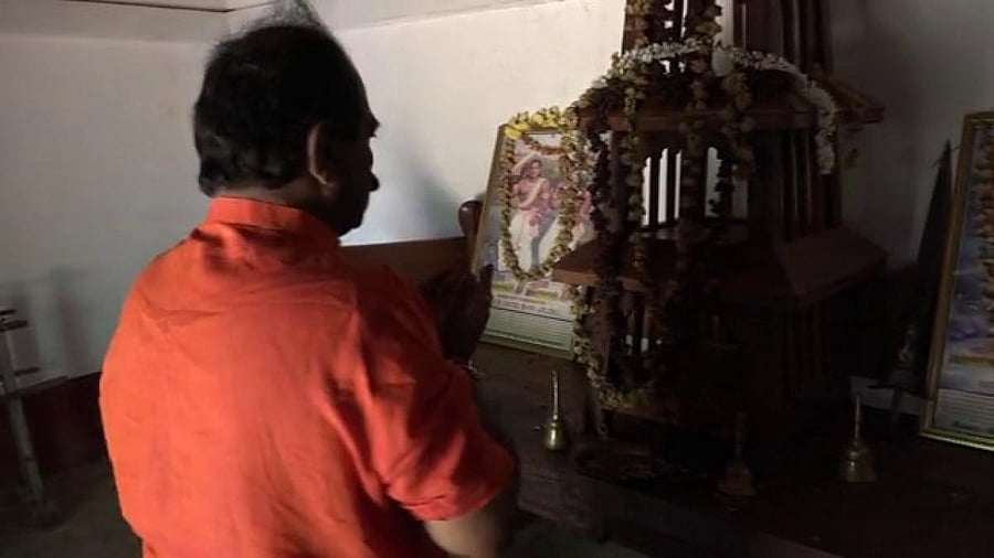 BJP leader Jagadish Adhikari offers prayers at a Garadi in Kellaputhige. Credit: DH Photo. 