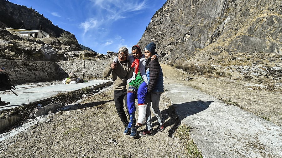 35-yr old Luxmi Devi being taken to a hospital during rescue operations in flood-hit Chamoli district of Uttarakhand. Credit: PTI Photo.