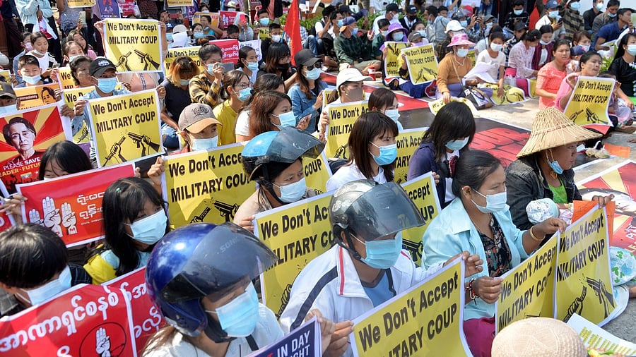 Protesters hold up signs during a demonstration against the military coup in Nay Pyi Daw on February 14, 2021. Credit: AFP Photo