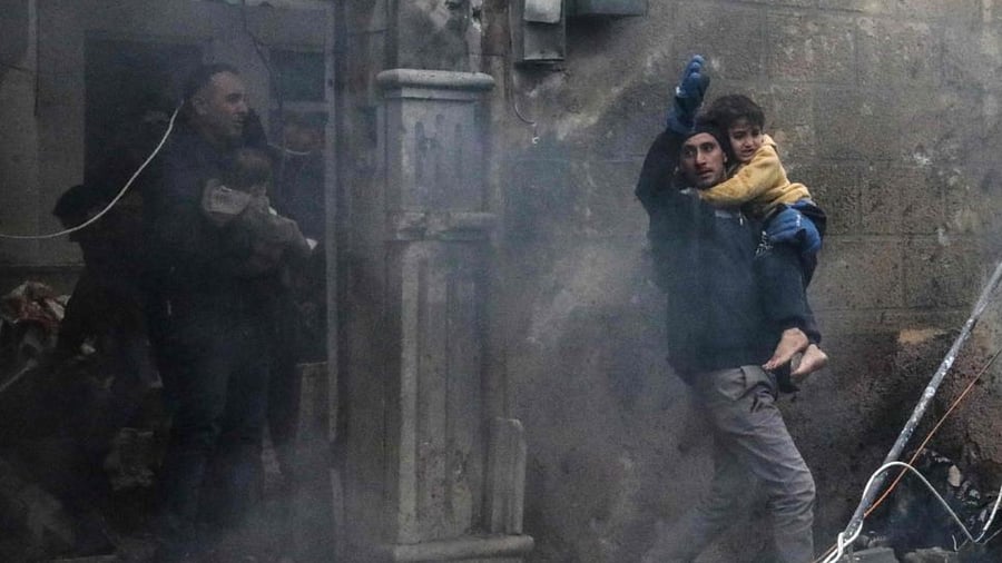 Civilians carry young victims at the scene of an explosion in the town of Azaz in the rebel-controlled northern countryside of Syria's Aleppo province,on January 31, 2021. Credit: AFP Photo
