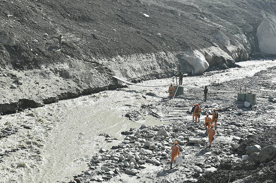 Army personnel build a bridge near Raini village, in the aftermath of a glacier burst in Uttarakhand's Joshimath that triggered a flash flood in Chamoli district, Sunday, Feb. 14, 2021. Credit: PTI Photo