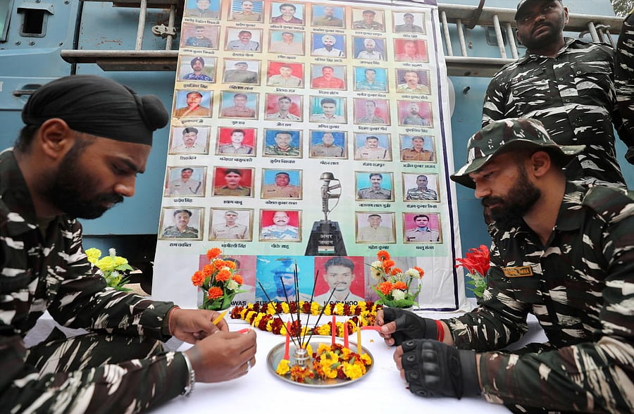 Central Reserve Police Force (CRPF) personnel pay tribute to the martyrs, on the eve of the second anniversary of Pulwama attack, in Jammu. Credit: PTI Photo. 