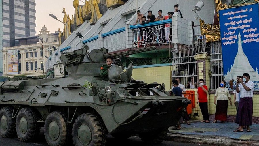 An armoured vehicle drives next to the Sule Pagoda, following days of mass protests against the military coup, in Yangon on February 14, 2021. Credit: AFP Photo