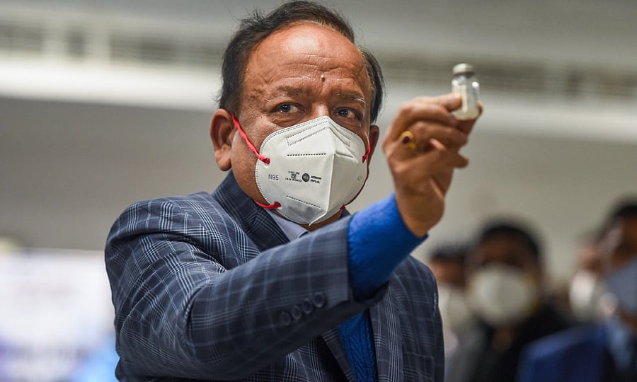 Union Health Minister Harsh Vardhan displays a Covishield vaccine vial, after the virtual launch of COVID-19 vaccination drive by Prime Minister Narendra Modi, at AIIMS in New Delhi, Saturday, Jan. 16, 2021. Credit: PTI File Photo