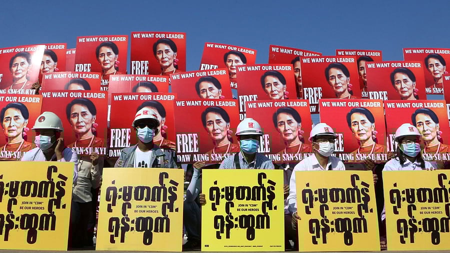 Demonstrators hold placards with the image of Aung San Suu Kyi during a protest against the military coup, in Nay Pyi Taw, Myanmar. Credit: Reuters Photo