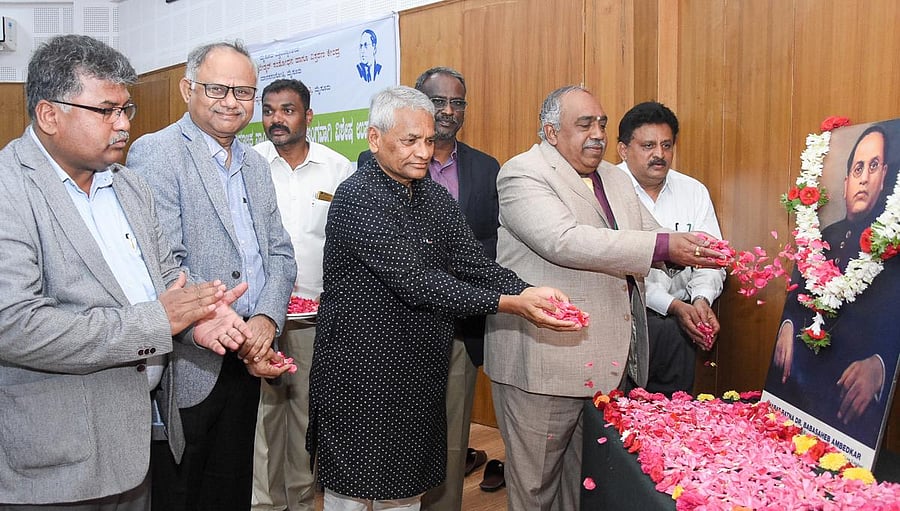 University of Mysore Vice-Chancellor G Hemantha Kumar and former advocate general Ravivarma Kumar pay floral tributes to a portrait of B R Ambedkar to mark World Day of Social Justice at Dr B R Ambedkar Research and Extension Centre, Manasagangotri, Mysur