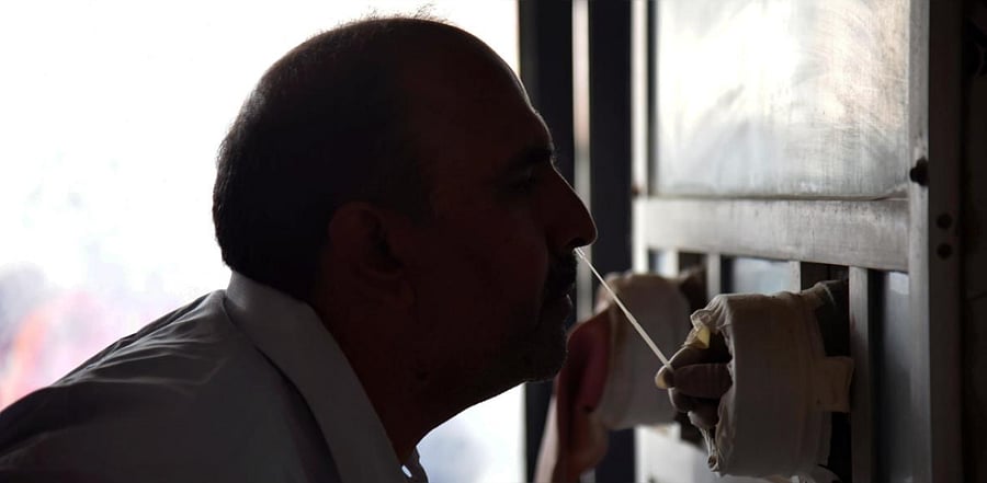 A health worker collects swab for the Covid-19 test following the rise in coronavirus cases, at a government hospital in Akola district, Maharashtra. Credit: PTI photo.