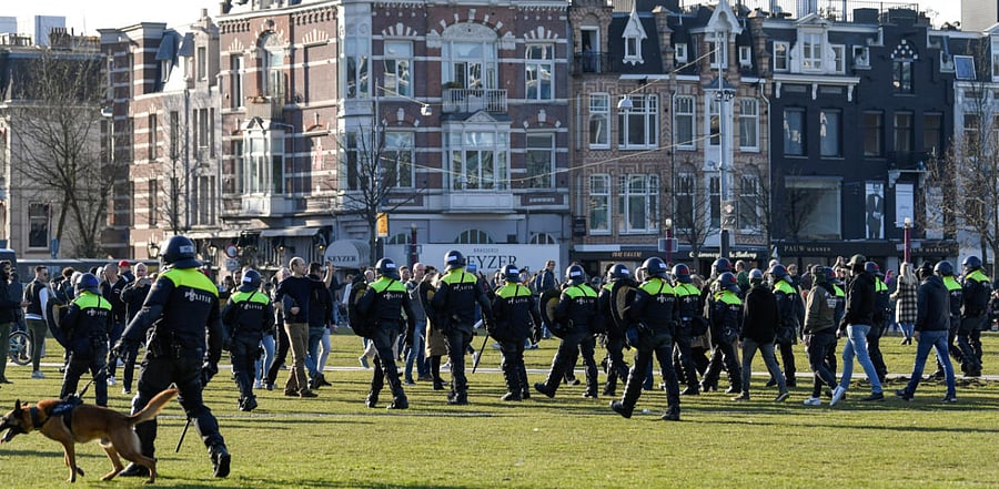 Police officers are seen, as people protest against the coronavirus disease (COVID-19) restrictions in Amsterdam, Netherlands. Credit: Reuters Photo