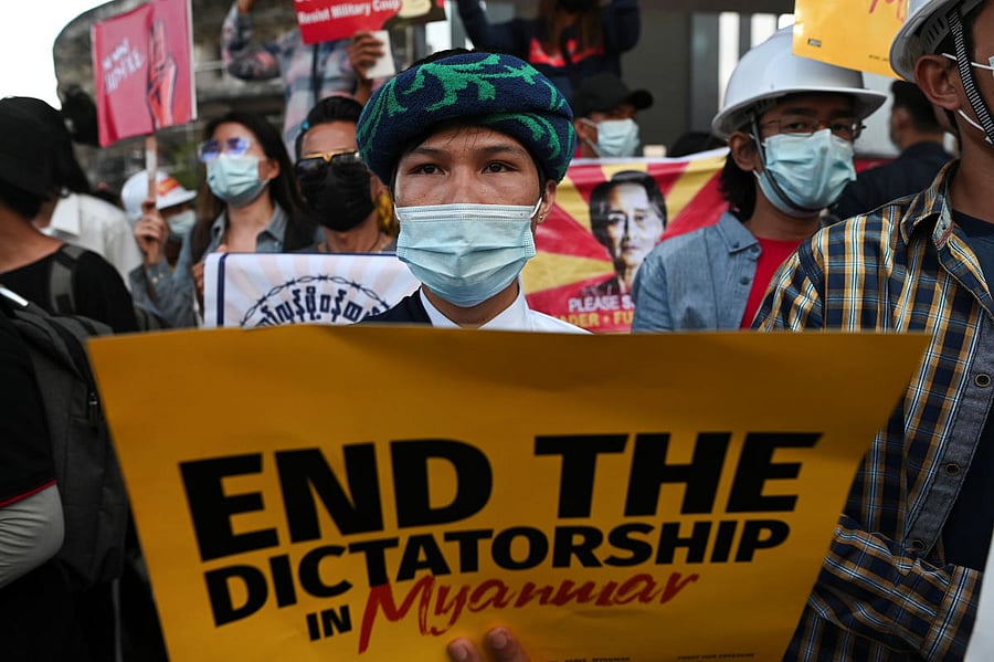 A protestor holds a placard as people rally against the military coup, in Yangon, Myanmar, February 20, 2021. Credit: REUTERS