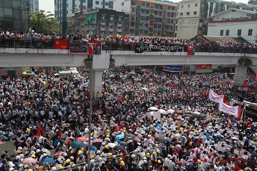 Anti-coup protesters gather at an intersection in downtown Yangon, Myanmar Monday, Feb. 22, 2021. Protesters gathered in Myanmar's biggest city Monday despite the ruling junta's thinly veiled threat to use lethal force if people answered a call for a general strike opposing the military takeover three weeks ago. Credit: AP/PTI Photo