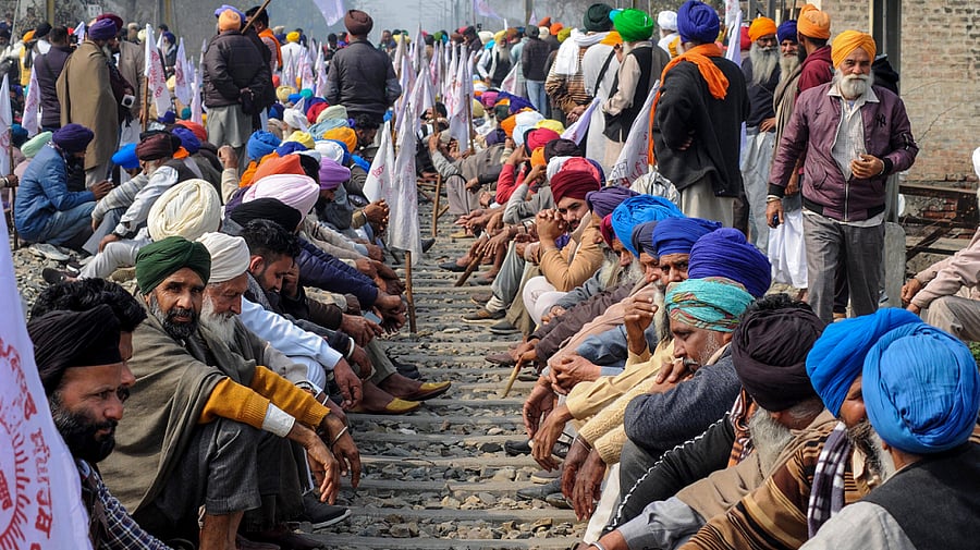 Members of various farmer organisations block a railway track during a four-hour 'rail roko' demonstration across the country. Credit: PTI Photo