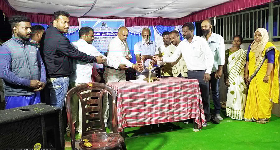 Dignitaries light the lamp before a Yakshagana performance at Golikatte Rehabilitation Layout in Made village.